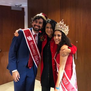 Karim Motani (left) and Alivia Mikahiel (right), along with UH President and UH System Chancellor Renu Khator (center) are crowned Homecoming King and Queen.