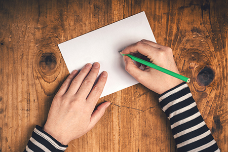 Photo: Hands writing with Pen