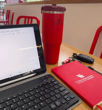 Photo: Laptop on table with water bottle