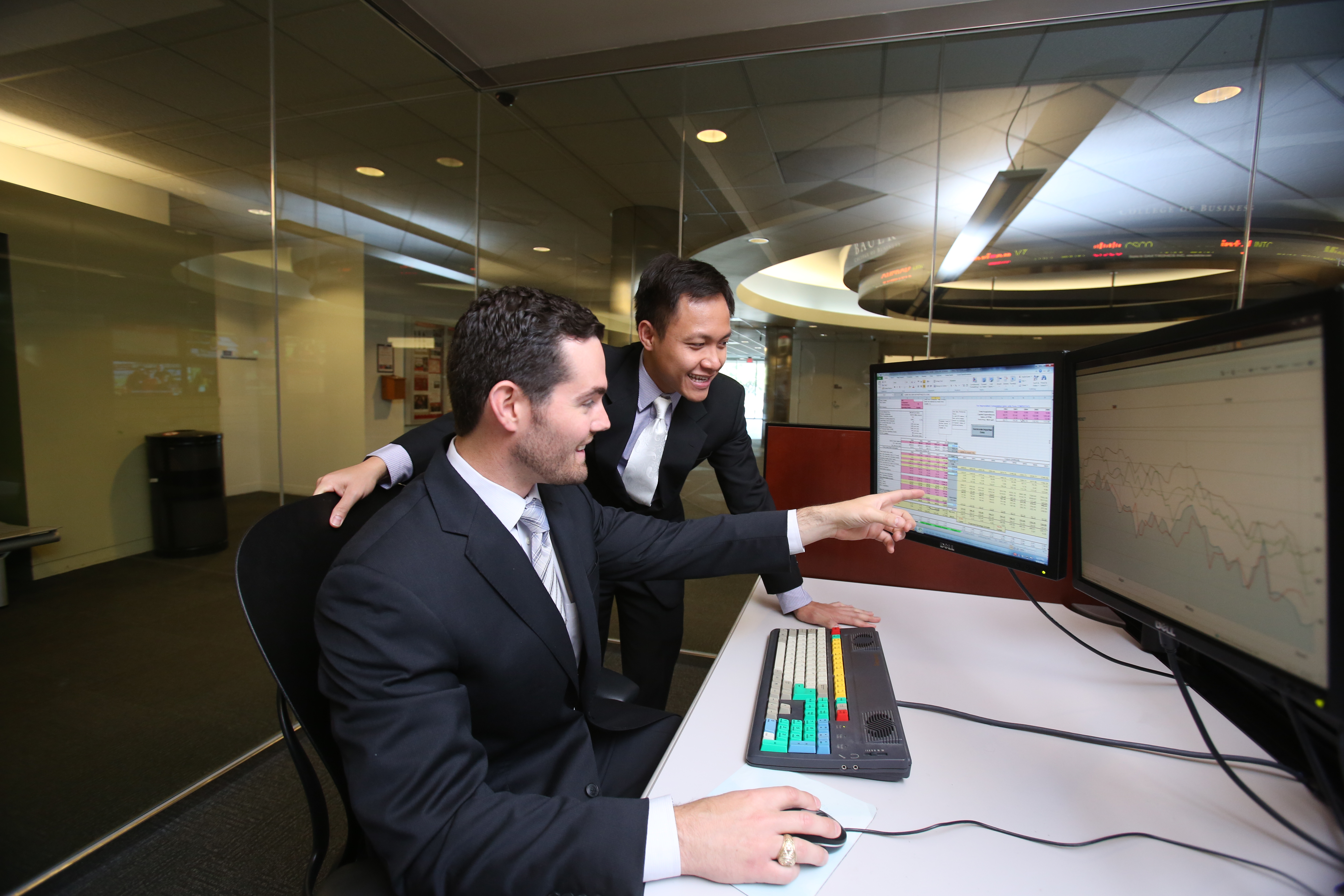 Bauer students Davison Nutt, left, and Wayne Q. Nguyen impressed the CFA Society of Houston with their work in the college’s Cougar Investment Fund and each received a scholarship from the organization.