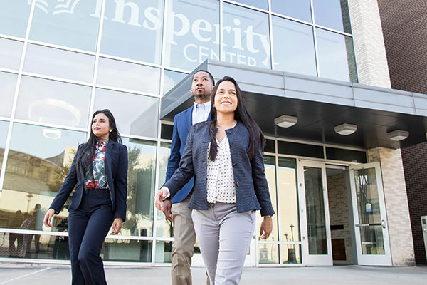 Photo of students walking out of the College Business Building