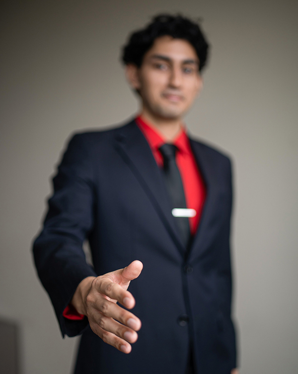 C. T. Bauer College of Business Student Shakes Hand